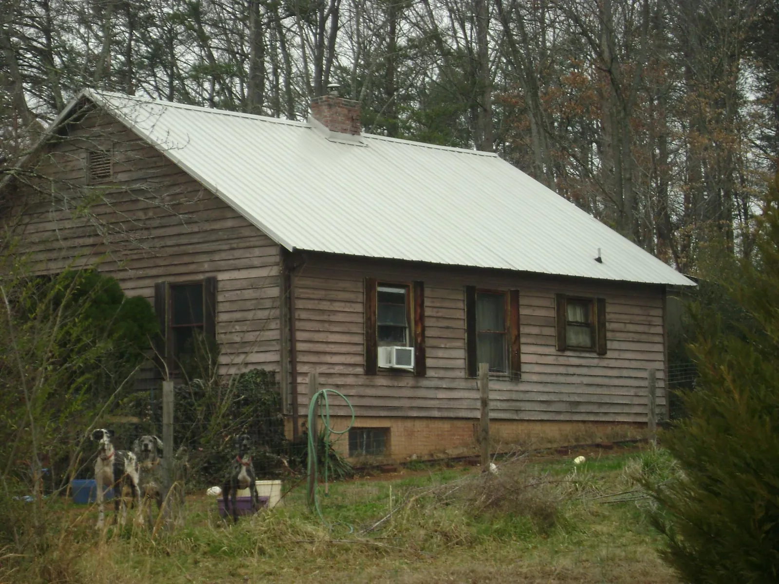 White metal roof on an old wood sided farmhouse, from a Metal Roof Installation job in Clarkesville